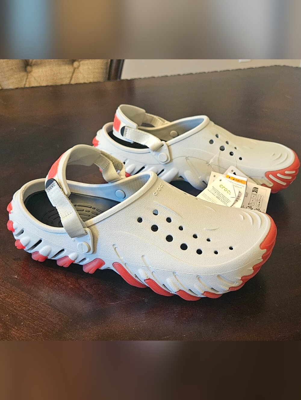 Crocs Echo Icy Ro clogs with red accents on the sole and heel strap
Size US 11
